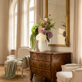 NO. 56 by Nicolíe de Luxe: lime, cream and mauve hydrangeas, pink anthurium, thistle, ferns and cascading green amaranthus in a cream jug vase, styled on a French walnut commode in an elegant villa salon
