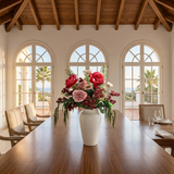 NO. 68 by Nicolíe de Luxe: crimson and blush peonies, burgundy berries and trailing amaranthus in a glossy white vase, styled on a walnut dining table in a Marbella villa dining room with sea-view arched windows
